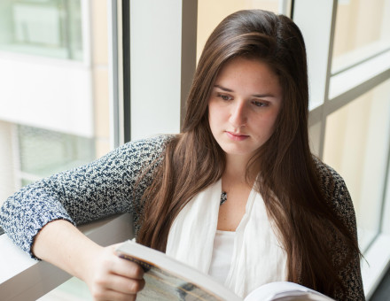 Student Reading in the Scheller College of Business. Photo: Fitrah Hamid